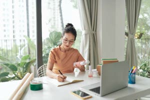 Small business owner preparing a batch of beauty products for shipping