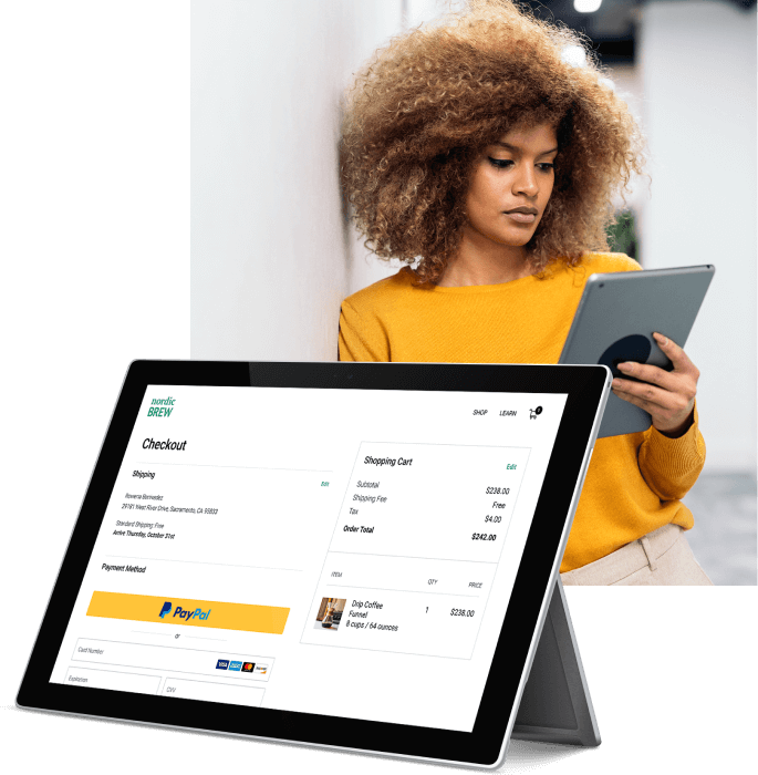 A woman is using her tablet to make a purchase online with PayPal