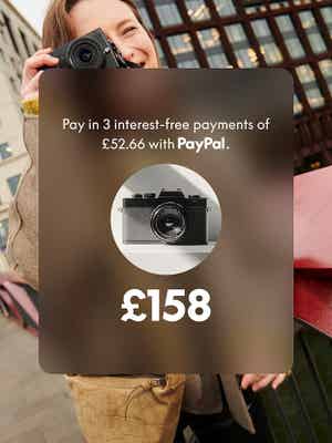 A smiling woman photographs with a camera; an overlay offers of Pay in 3